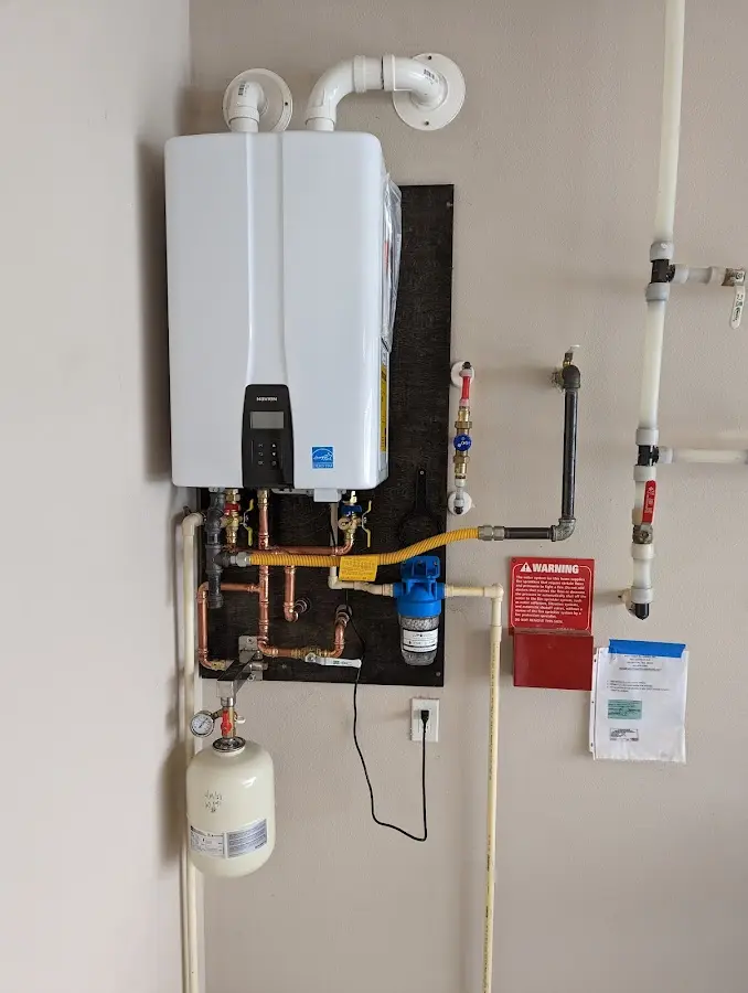 Professional plumber installing copper piping in a Moorefield home